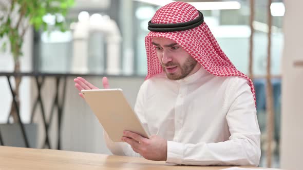 Disappointed Arab Businessman Having Loss on Tablet in Office