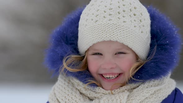 Portrait of funny little girl in outerwear,