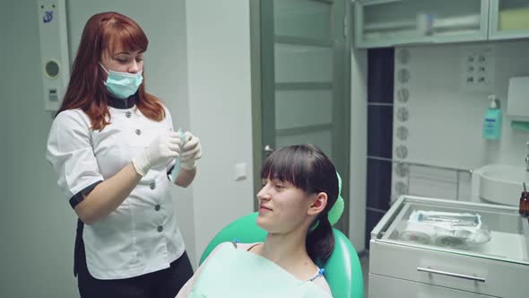 Woman at the dentist smiling. Work of stomatologist with patient. Make your smile perfect.