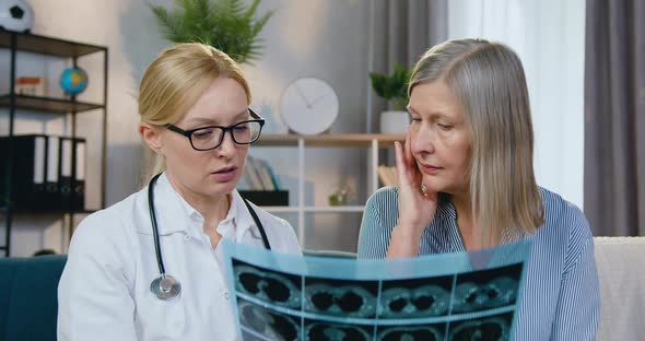 Woman-Doctor Comforting Her Patient After they Both Looked X-ray Scan During Home Visit