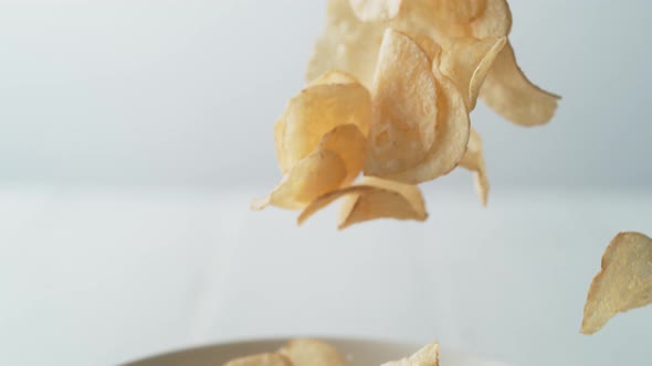 Putting potato chips in a bowl. Slow Motion.