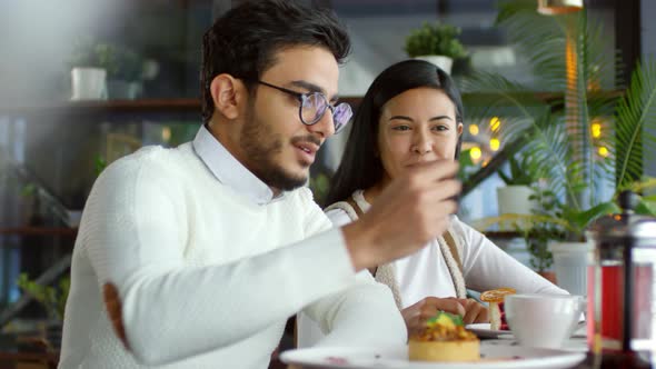 Young Couple Having Tea and Desserts on Date in Cafe