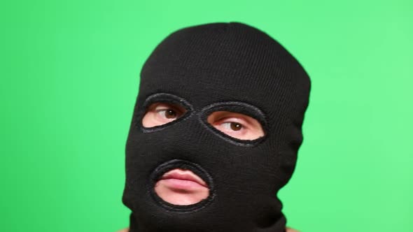 Scary Thief or Robber in Mask Looking at Camera