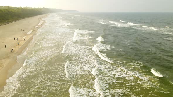 Spectacular Sunset over Families at the Beach on a Dark Cold Day during the Evening Sunset, Drone Ae