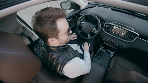 A Man Sits in a Car While It Self-parking.