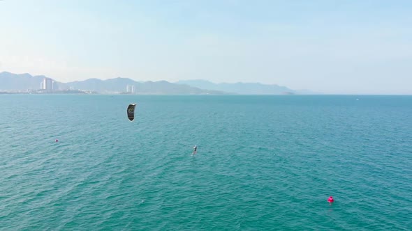 Aerial View of the City Beach and Active People Practicing Kite Surfing and Windsurfing. Kitesurfing