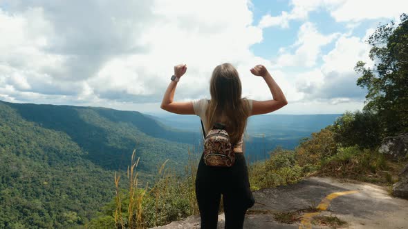 Young Woman Hiker with Backpack in Trip at Mountain Peak Standing with View