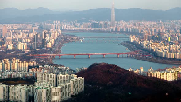 Timelapse Buildings on River Banks Against Hills of Seoul