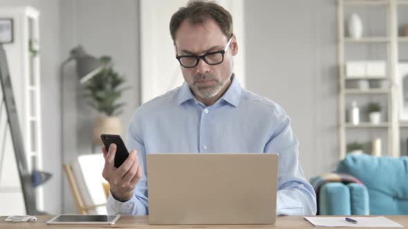 Old Businessman Using Smartphone