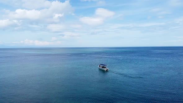 Aerial drone flying over aing dive boat on stunning coral reef ocean at tropical island getaway dest