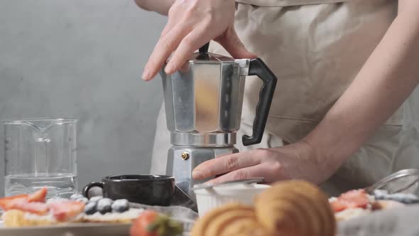 Woman or Girl Turn Out Geyser Coffee Maker to Pour Water and Put Ground Coffee in It