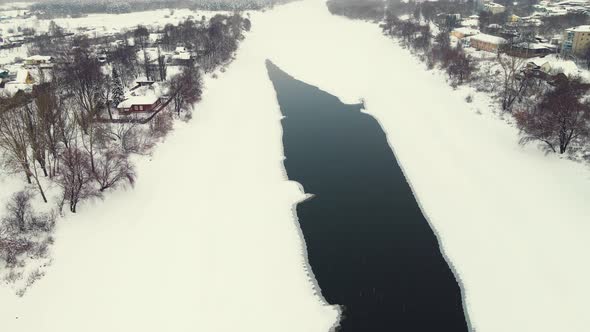 Beautiful Winter Landscape with Frozen River and Suburbs Aerial View