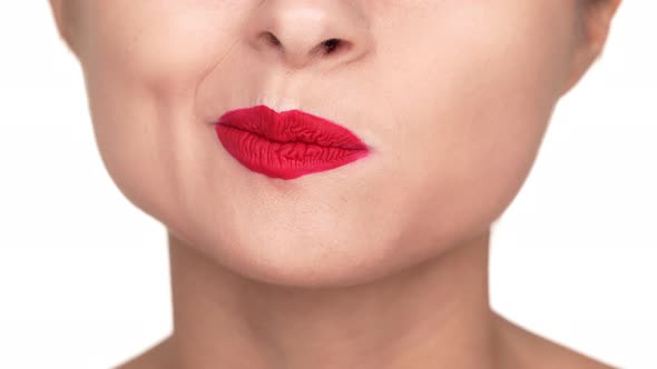 Extreme Close Up Portrait of Irritated Female Person Twisting Her Lips Covered with Red Matte