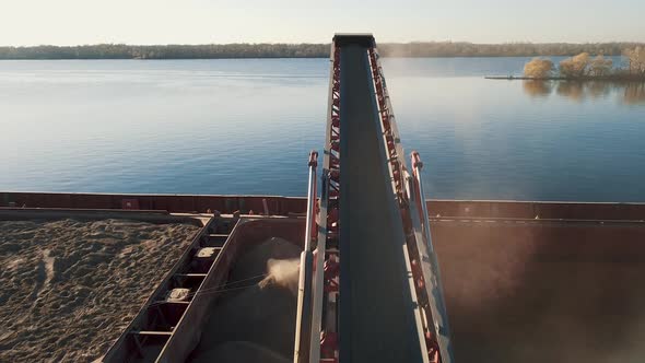 Big grain terminal at seaport. Cereals bulk transshipment from road transport to vessel. 