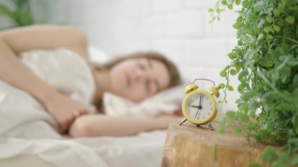 Beautiful Young Woman Opens Her Eyes and Wakes Up in Bed at Seven O'clock in the Morning