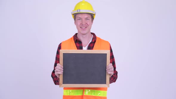 Happy Young Man Construction Worker Holding Blackboard