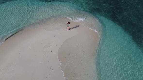 Aerial View of a Beach Surrounded By Waves with a Woman Sunbathing Lying on a Sand