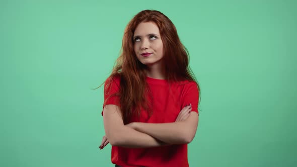 Irritated Woman in Orange Sighs Rolling Eyes on Green Background