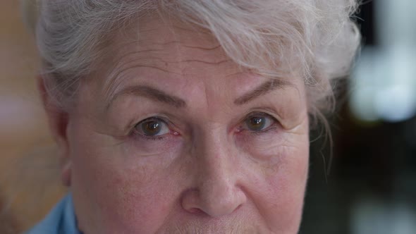 Closeup Eyes of Senior Positive Caucasian Woman Looking at Camera