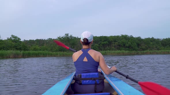 A Woman Is Kayaking