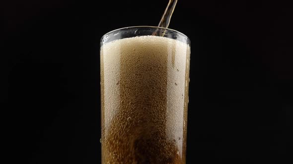 Pouring coke/cola/soda into a glass