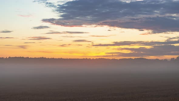 Time lapse evening fog with sunset and beautiful twilight fluffy storm cloudy blue and yellow sky