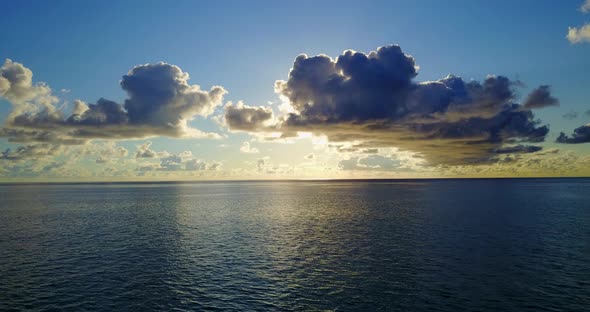 Wide angle above clean view of a sunshine white sandy paradise beach and blue ocean background in hi