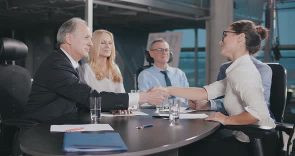 Team of Managers Signing Contract at Corporate Meeting