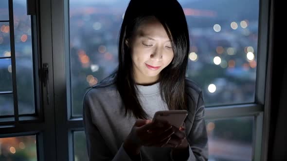 Woman use of mobile phone at night