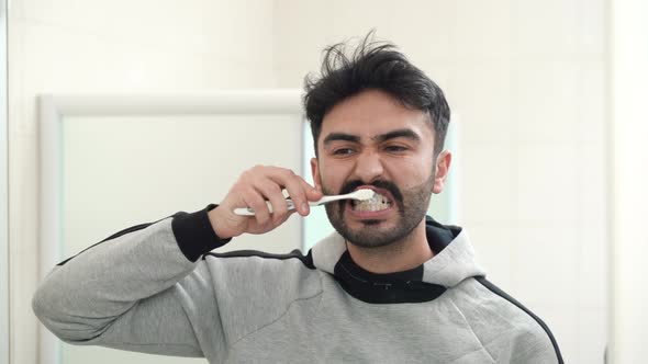 Man brushing his teeth.