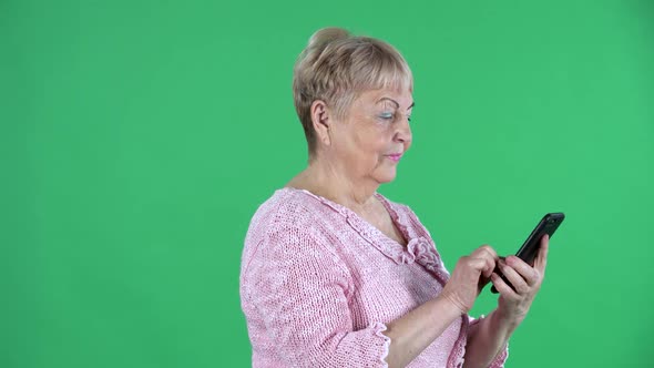 Portrait Elderly Woman Texting on Her Smartphone