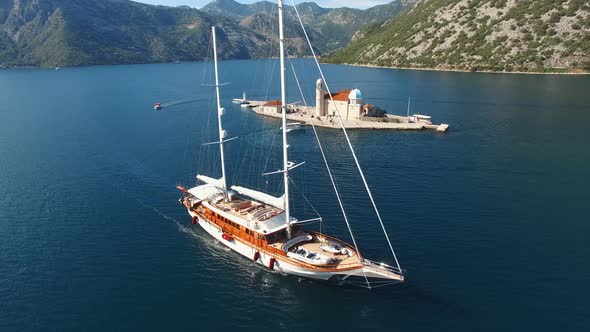 White Sailing Yacht Sails Past the Island of Gospa Od Skrpjela