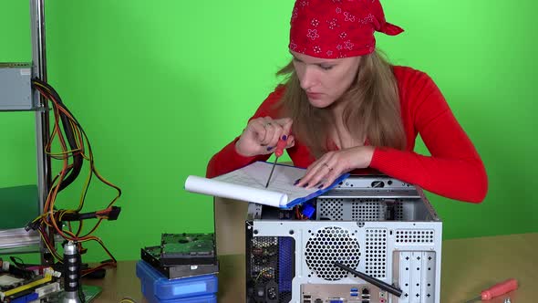 Technician Woman Examining Computer Hardware and Clipboard in Hands