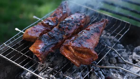 Delicious Beef or Pork Ribs Frying on a Charcoal Grill
