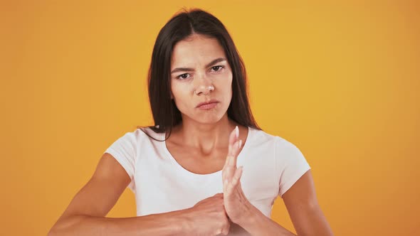 Angry Woman is Grinning and Hitting Her Fist in Palm