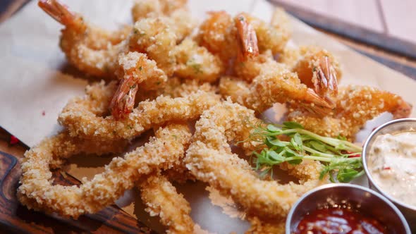 Tasty shrimps in breading cooked in deep fryer oven for beer snack in bar