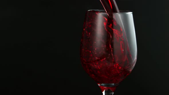 Pouring Red Wine in Super Slow Motion on Black Background
