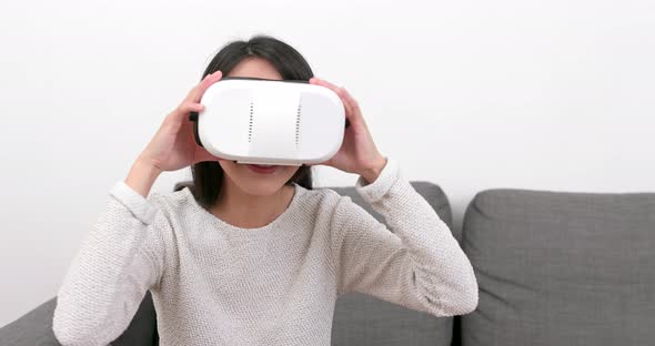 Woman looking with VR device at home