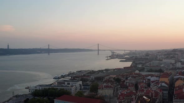 Aerial Slider View of Ponte 25 De Abril Red Bridge Across the Sea Canal in Lisbon Portugal with