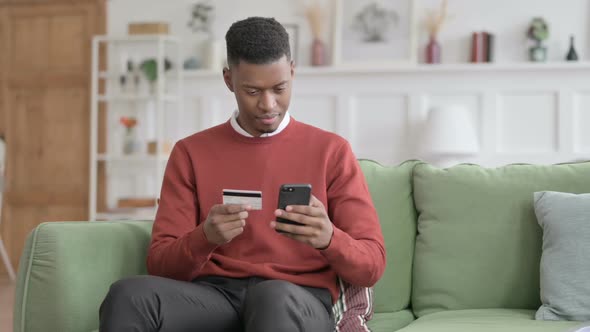 African Man Unsuccessful Online Payment on Smartphone