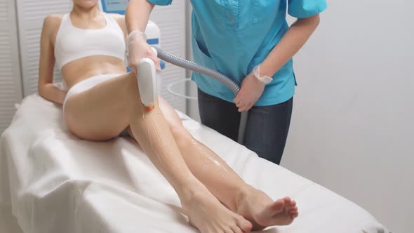 Young Slender Woman Getting Laser Epilation in Salon.
