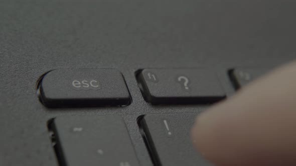 Finger Presses Escape Button on Keyboard.