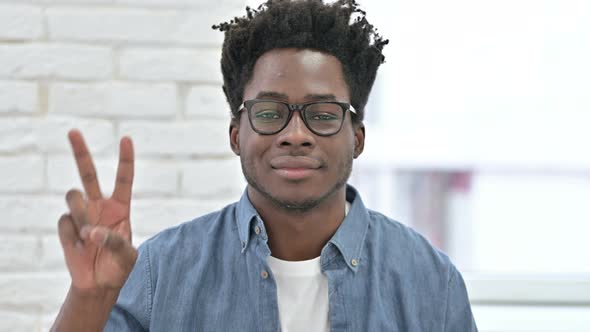 Young African Man Showing Victory Sign 