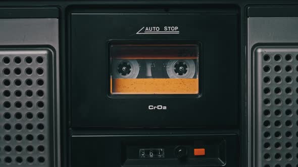 Vintage Yellow Audio Cassette Playing in Deck of an Old Tape Recorder