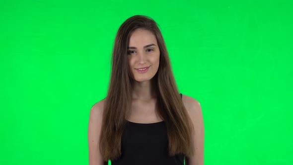 Woman Standing, Spreads Out in a Smile and Looks at the Camera. Green Screen