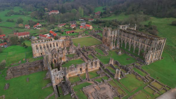 Aerial view towards the remains of North Yorkshire Rievaulx Abbey historical building ruins, Helmsle
