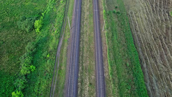 Drone Shot Showing Railroad Tracks Among Fields