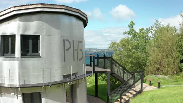 AERIAL - Flying from a wide to the balcony of the quirky aluminium Scottish house