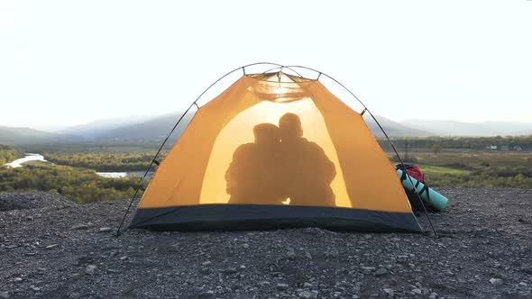 View From the Tent of Shadow Man and Woman Hugging in the Mountain.