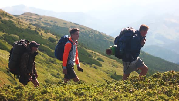 Tourists with Backpacks Walking on Trek